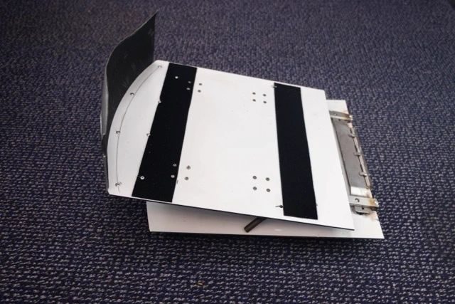 Seat cushion assembly with black anti-slip strips on the seat pan, photographed on the cabin floor.
